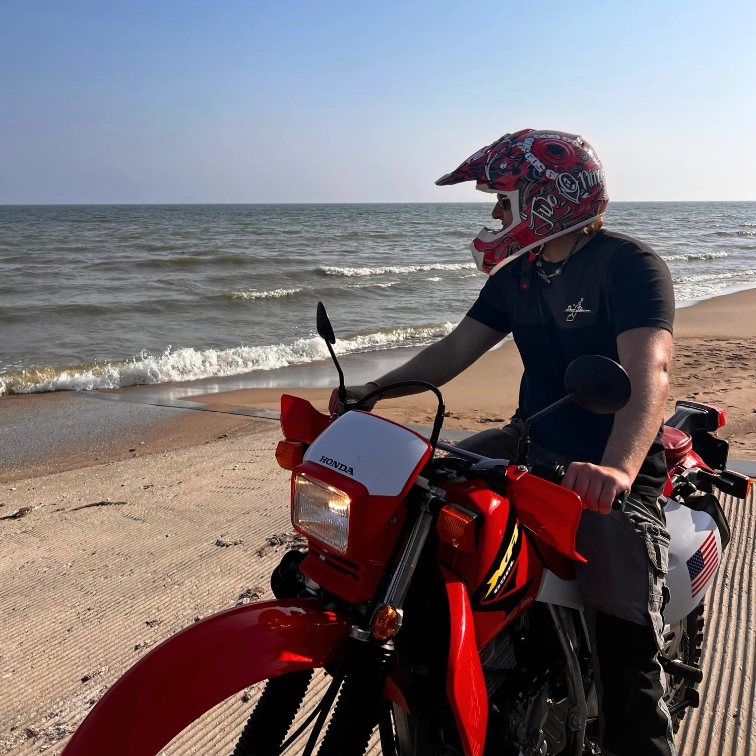 Man on Lake Michigan Beach Wearing Graphic T-Shirt on Dirt Bike in Summer